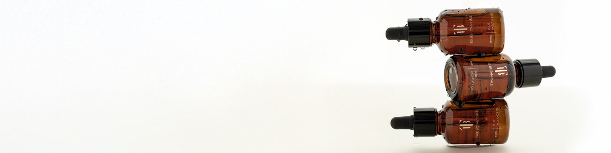 3 oils stacked on top of each other on a white background